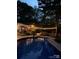 Inviting backyard pool area with string lights, patio furniture, and lush landscaping, perfect for relaxing evenings at 9417 Valley Rd, Charlotte, NC 28270