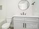 Clean bathroom featuring white vanity, a round mirror, and contemporary fixtures for a sleek look at 110 Walters St, Huntersville, NC 28078