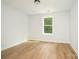 Inviting bedroom features wood floors, a bright window, and neutral walls for a relaxing atmosphere at 110 Walters St, Huntersville, NC 28078