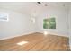 Bright bedroom featuring wood floors, large windows, and neutral paint, creating a serene and inviting atmosphere at 110 Walters St, Huntersville, NC 28078