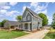 Charming two-story home features a welcoming front porch, gray siding, and a well-manicured lawn at 110 Walters St, Huntersville, NC 28078