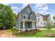 Attractive two-story home with a covered front porch and well-maintained landscaping at 110 Walters St, Huntersville, NC 28078