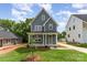 Inviting two-story home with a manicured lawn, covered porch, and well-maintained landscaping at 110 Walters St, Huntersville, NC 28078