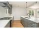 Modern kitchen featuring stainless steel appliances, granite countertops, and sleek gray cabinetry at 110 Walters St, Huntersville, NC 28078