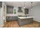 Modern kitchen features a functional island, gray cabinetry, stainless steel appliances, and sleek design at 110 Walters St, Huntersville, NC 28078