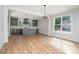 Stylish kitchen and breakfast area with stainless appliances, island, pendant lights and plentiful natural light at 110 Walters St, Huntersville, NC 28078