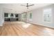 Spacious living room featuring hardwood floors, lots of natural light, and seamless flow to the kitchen at 110 Walters St, Huntersville, NC 28078