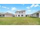 A lush green backyard is the setting for a two-story home with gray siding and dark roof at 1113 Foxberry Ln, Maiden, NC 28650