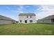 The large grassy backyard is the setting for a home with a sliding door entrance to the home at 1113 Foxberry Ln, Maiden, NC 28650