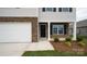 Close up of the front exterior featuring stone accents and a well-manicured front yard at 1113 Foxberry Ln, Maiden, NC 28650