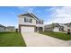 Two story home featuring stone accents, a two-car garage, and a well-manicured lawn at 1113 Foxberry Ln, Maiden, NC 28650