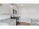 Kitchen featuring stainless steel appliances, grey cabinets, and granite countertops at 1113 Foxberry Ln, Maiden, NC 28650