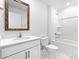 Bathroom featuring single sink, white cabinets, combination tub and shower and tile floor at 1117 Foxberry Ln, Maiden, NC 28650