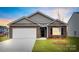 Charming brick home featuring a two-car garage, black door and shutters, and manicured lawn at 1117 Foxberry Ln, Maiden, NC 28650