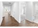 Bright hallway featuring hardwood floors and views into the spacious living areas and a bathroom at 1117 Foxberry Ln, Maiden, NC 28650