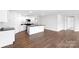 Open-concept kitchen with an island, granite countertops, white cabinetry, and stainless steel appliances at 1117 Foxberry Ln, Maiden, NC 28650
