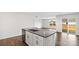 Kitchen featuring granite countertops, white cabinets, stainless steel dishwasher, and an island sink at 1117 Foxberry Ln, Maiden, NC 28650