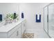 Modern bathroom with double sink, white cabinets, glass enclosed shower and marble floors create a clean aesthetic at 1129 Foxberry Ln, Maiden, NC 28650