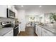 Modern kitchen with granite countertops, stainless steel appliances, and an open view to the dining area at 1129 Foxberry Ln, Maiden, NC 28650
