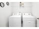 Functional laundry room equipped with washer, dryer, shelving offering practical space and storage at 1129 Foxberry Ln, Maiden, NC 28650