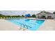 Community pool view featuring a pool, lounge chairs, umbrellas and clubhouse at 1129 Foxberry Ln, Maiden, NC 28650