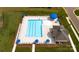 Aerial view of a community pool with lounge chairs, umbrellas, and clubhouse at 1129 Foxberry Ln, Maiden, NC 28650