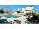 This backyard oasis features a pool, patio, mature trees and cozy fire pit seating area at 11307 Celandine Ct, Charlotte, NC 28213