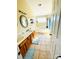 A spacious bathroom features a double sink vanity, a large soaking tub with a window above, and tan tile flooring at 11307 Celandine Ct, Charlotte, NC 28213