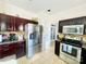 Well-equipped kitchen featuring stainless steel appliances and beautiful dark cherry cabinets at 11307 Celandine Ct, Charlotte, NC 28213