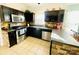 Modern kitchen with stainless steel appliances, granite countertops, and dark wood cabinetry at 11307 Celandine Ct, Charlotte, NC 28213