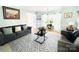 Bright living room featuring comfortable sofas, a stylish rug, and ample natural light at 11307 Celandine Ct, Charlotte, NC 28213