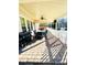 Covered patio with ceiling fan and dining set offer pleasant outdoor living space and backyard access at 11307 Celandine Ct, Charlotte, NC 28213