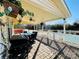 Covered patio overlooking the pool. Great place to enjoy time outside with a grill, table, chairs, and ceiling fan at 11307 Celandine Ct, Charlotte, NC 28213
