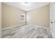 A bright bedroom featuring light gray wood-look flooring and a neutral color palette at 119 Front Porch Dr # 46, Rock Hill, SC 29732