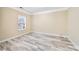 Bright bedroom with light hardwood floors, neutral paint, and natural light through a window at 119 Front Porch Dr # 46, Rock Hill, SC 29732