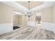 Elegant dining room featuring hardwood floors, chair rail, modern light fixture, and open floor plan at 119 Front Porch Dr # 46, Rock Hill, SC 29732