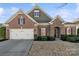 Charming home with a brick and stone facade, two-car garage, and well-maintained landscaping at 119 Front Porch Dr # 46, Rock Hill, SC 29732
