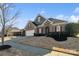 Beautiful home with brick and stone facade, red shutters, manicured lawn, and lovely curb appeal at 119 Front Porch Dr # 46, Rock Hill, SC 29732