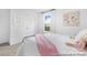 Cozy bedroom showcasing a comfortable bed with pink accents, soft natural light, and modern decor at 119 Stonewater Dr # 22, Red Cross, NC 28129