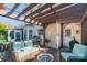 Back deck features an outdoor kitchen and cozy wicker seating underneath a pergola at 12112 Autumn Winds Ln, Pineville, NC 28134