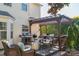 Entertain on the covered back deck with wicker chairs, grill, and outdoor space at 12112 Autumn Winds Ln, Pineville, NC 28134