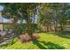 Expansive back yard boasts mature trees, lush lawn, and deck with outdoor seating at 12112 Autumn Winds Ln, Pineville, NC 28134