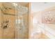 Bathroom showcasing a tile surround shower with a glass door and a soaking tub at 12112 Autumn Winds Ln, Pineville, NC 28134