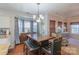Cozy dining area with a wooden table, upholstered chairs, and bright window light at 12112 Autumn Winds Ln, Pineville, NC 28134