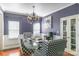 Elegant dining room with a chandelier, glass table, and stylish patterned chairs at 12112 Autumn Winds Ln, Pineville, NC 28134
