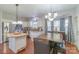Open kitchen and dining area with stainless steel appliances and wooden table at 12112 Autumn Winds Ln, Pineville, NC 28134