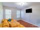 Comfortable living room with hardwood floors, a large sofa, and natural light at 12112 Autumn Winds Ln, Pineville, NC 28134