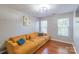 Comfortable living room with hardwood floors, a large sofa, and natural light at 12112 Autumn Winds Ln, Pineville, NC 28134