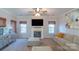 Comfortable living room with a fireplace, neutral decor, and ample seating at 12112 Autumn Winds Ln, Pineville, NC 28134