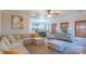 Open-concept living room with plush seating flows into the adjacent kitchen area at 12112 Autumn Winds Ln, Pineville, NC 28134